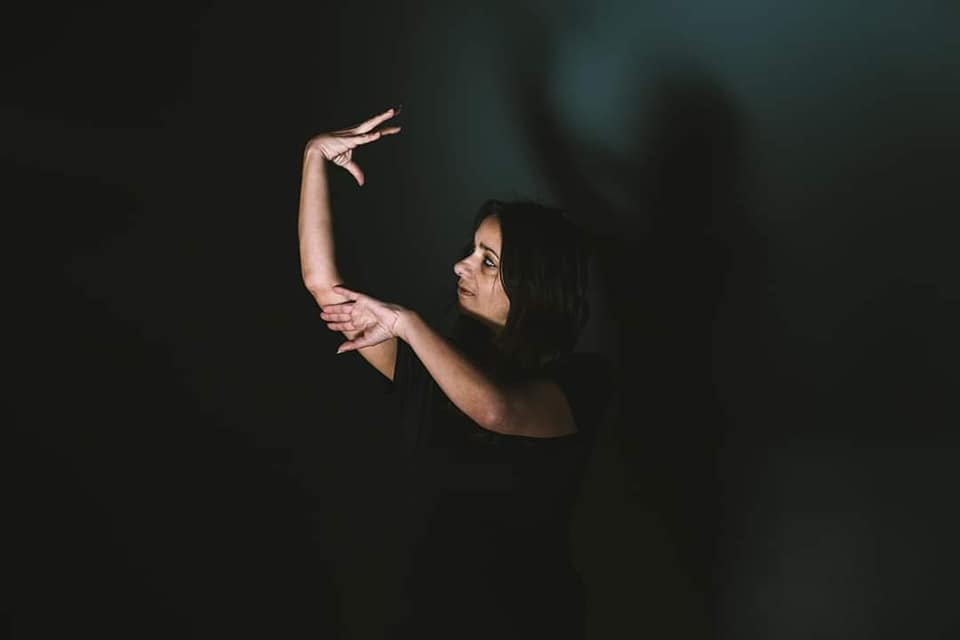Personne interprétant une chanson en langue des signes française (LSF) lors d'un atelier de chansigne, mêlant musique, expression corporelle et émotion.
